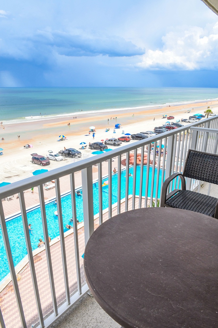 Breathtaking coastal views stretch before you from this private balcony perch, overlooking the sparkling pool, golden sands, and turquoise ocean waves meeting an endless sky.