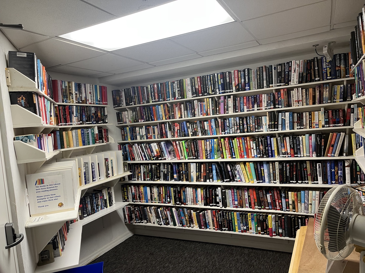 Curl up with your favorite book in this incredible library room featuring floor-to-ceiling shelves packed with hundreds of titles.