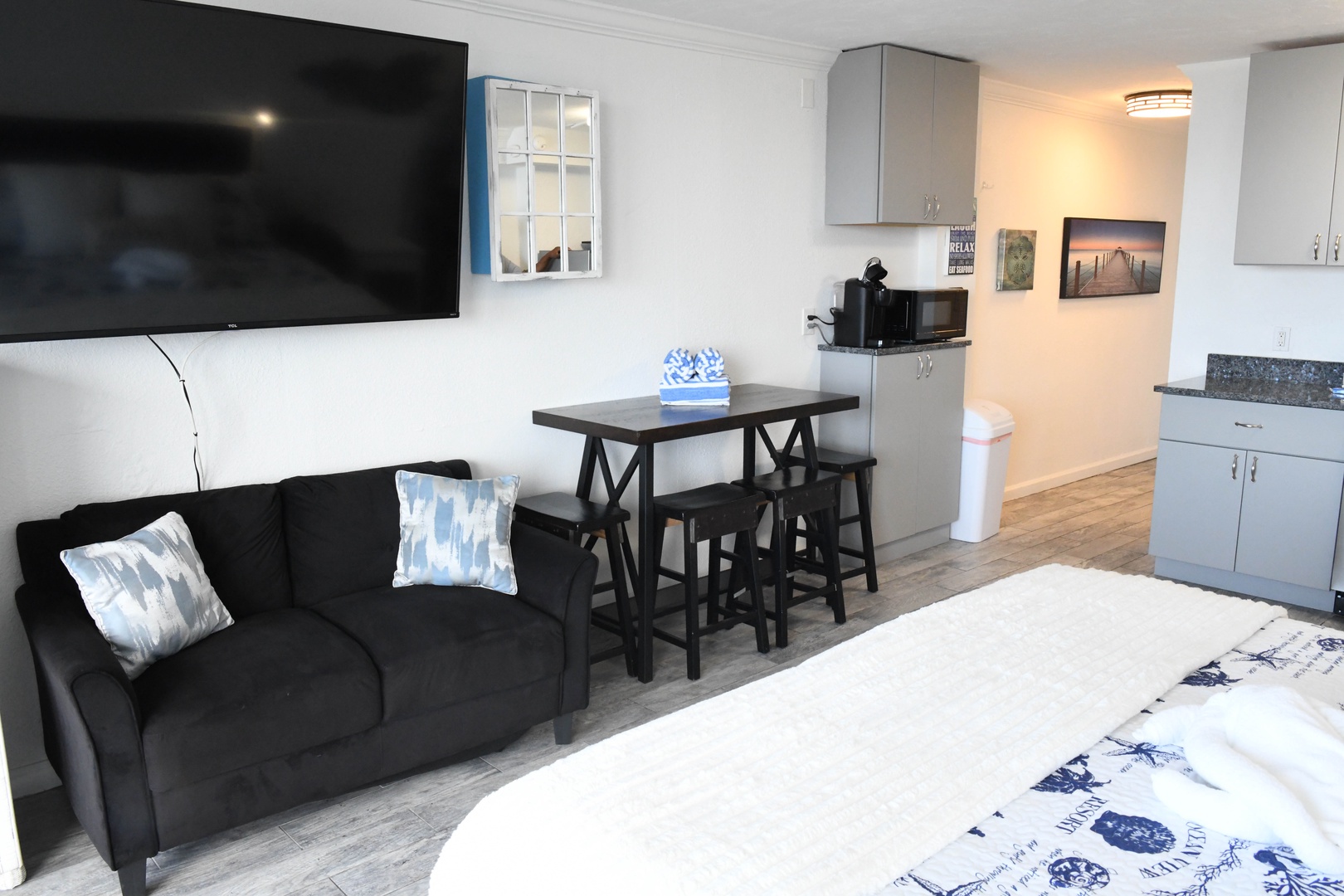 Step into your bright, modern studio with everything you need. Relax on the plush sofa, catch up on shows, enjoy meals at the cozy dining nook, and unwind on your comfy bed.