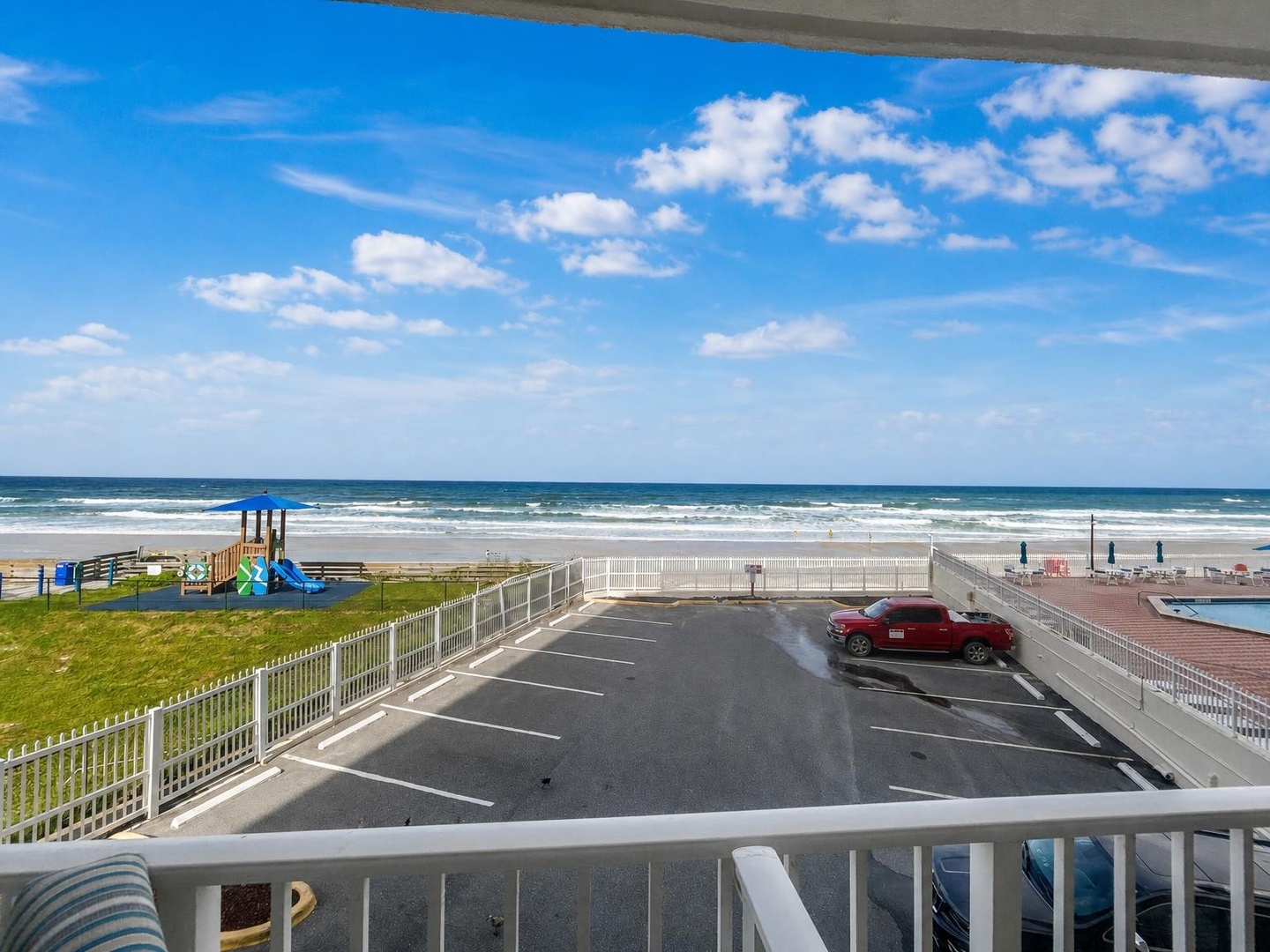 The property sits just steps from a sandy beach, with direct access to the waterfront area and recreational facilities. A convenient parking area makes arrival easy and seamless.