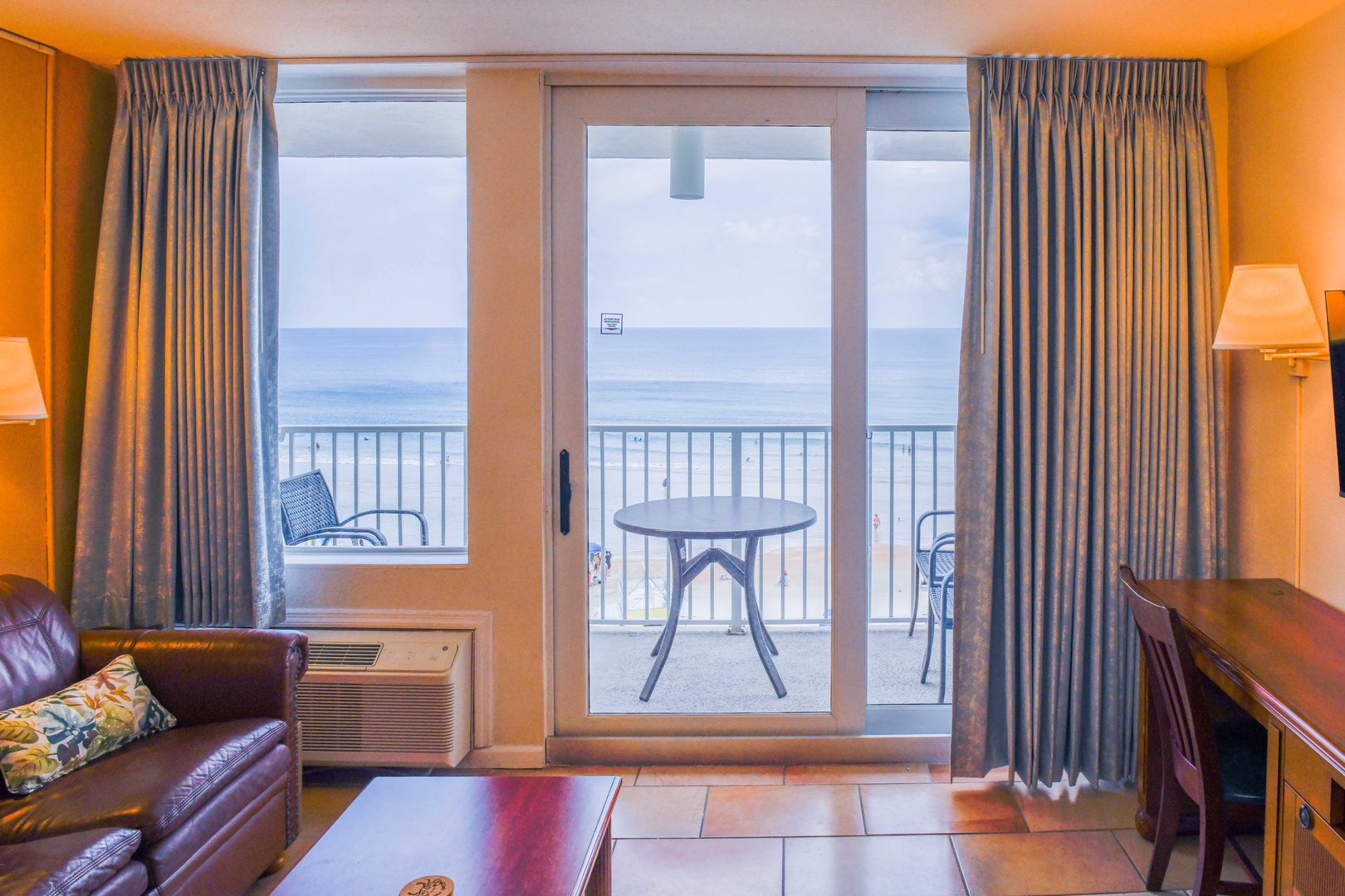 Settle into your cozy living space with stunning sea views right from your private balcony. Sink into the leather seating, feel the ocean breeze, and unwind in comfort.