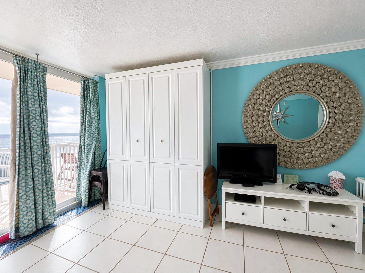 Your coastal retreat welcomes you with calming turquoise walls and charming nautical accents. Step onto your private balcony to feel the ocean breeze and soak in stunning sea views.