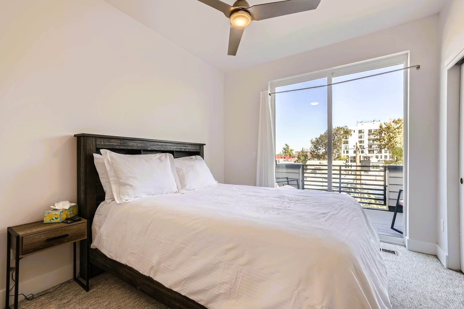 Sink into crisp white linens while your private balcony frames city views through floor-to-ceiling windows.