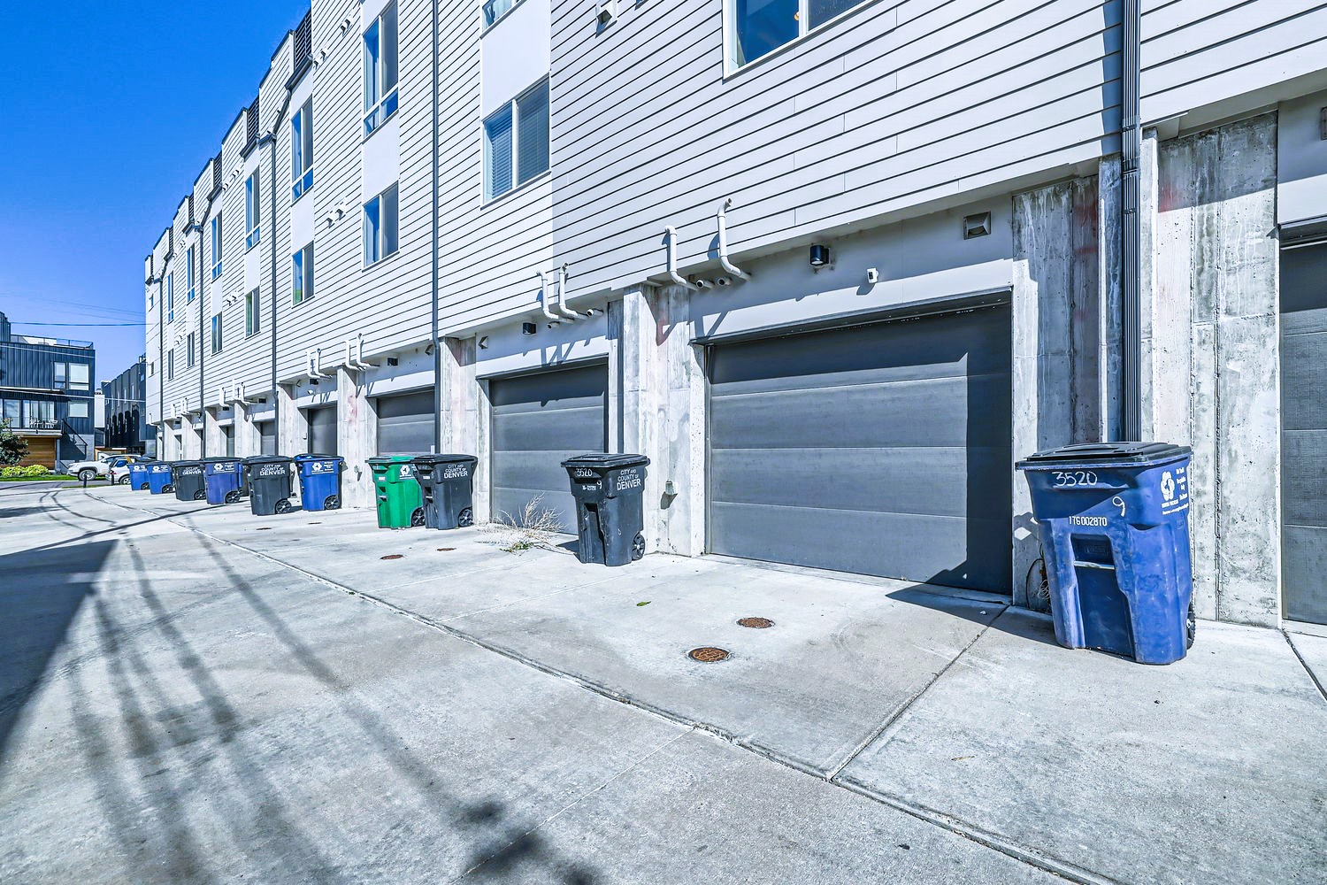 Modern townhouse complex with private garages and convenient parking for each unit.