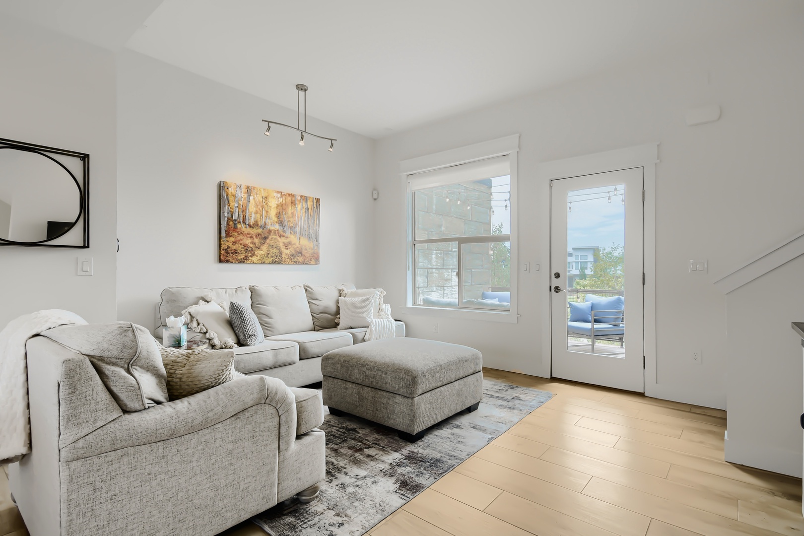 Sink into plush seating after a day of exploring, with warm autumn artwork and natural light creating your serene retreat.