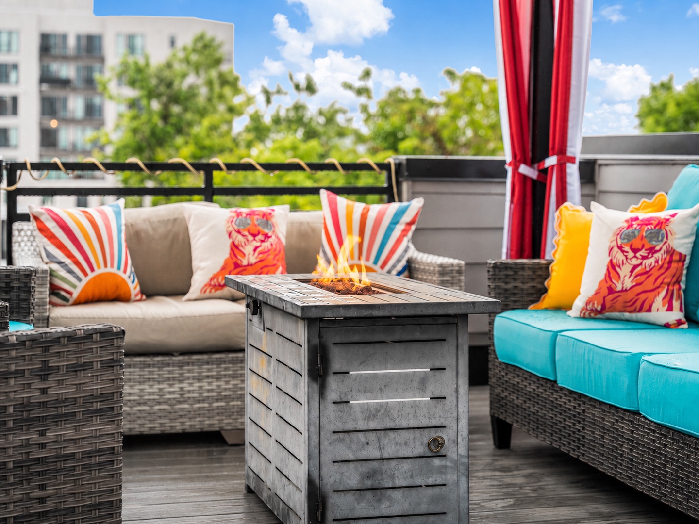 Vibrant patio with plush seating, a cozy fire table, and cheerful accents—your perfect spot to unwind under the open sky.