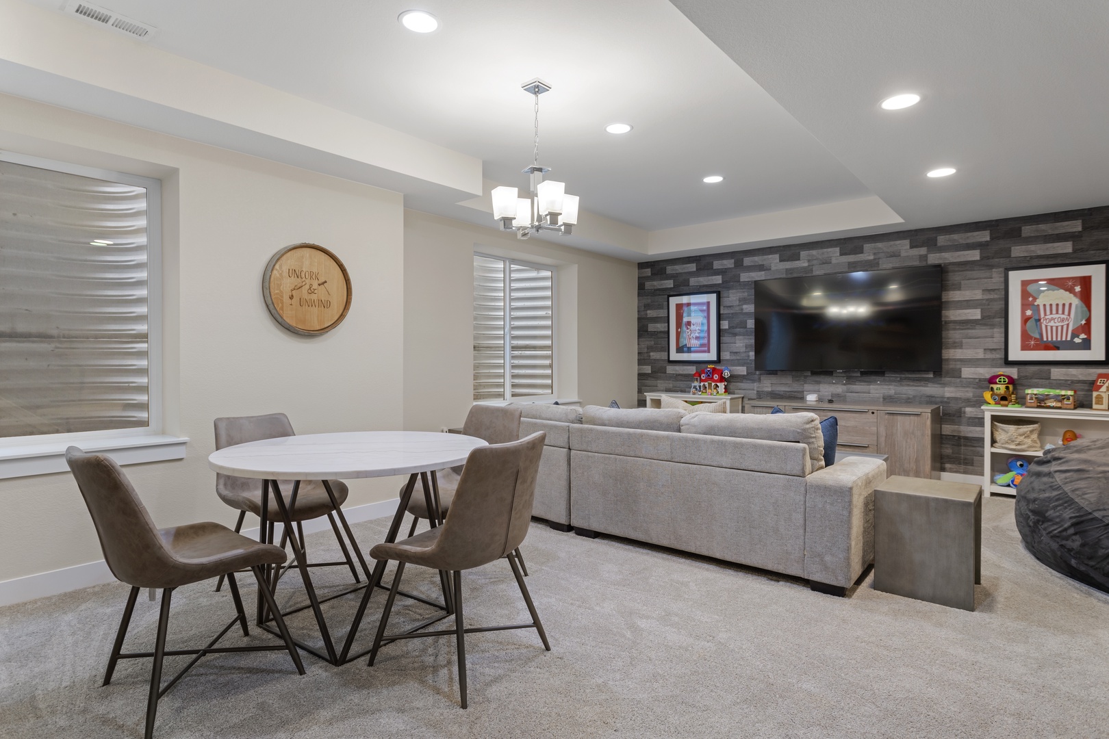 Your stylish basement retreat combines dining and lounging perfectly, with modern sectional seating and entertainment center for memorable family gatherings.