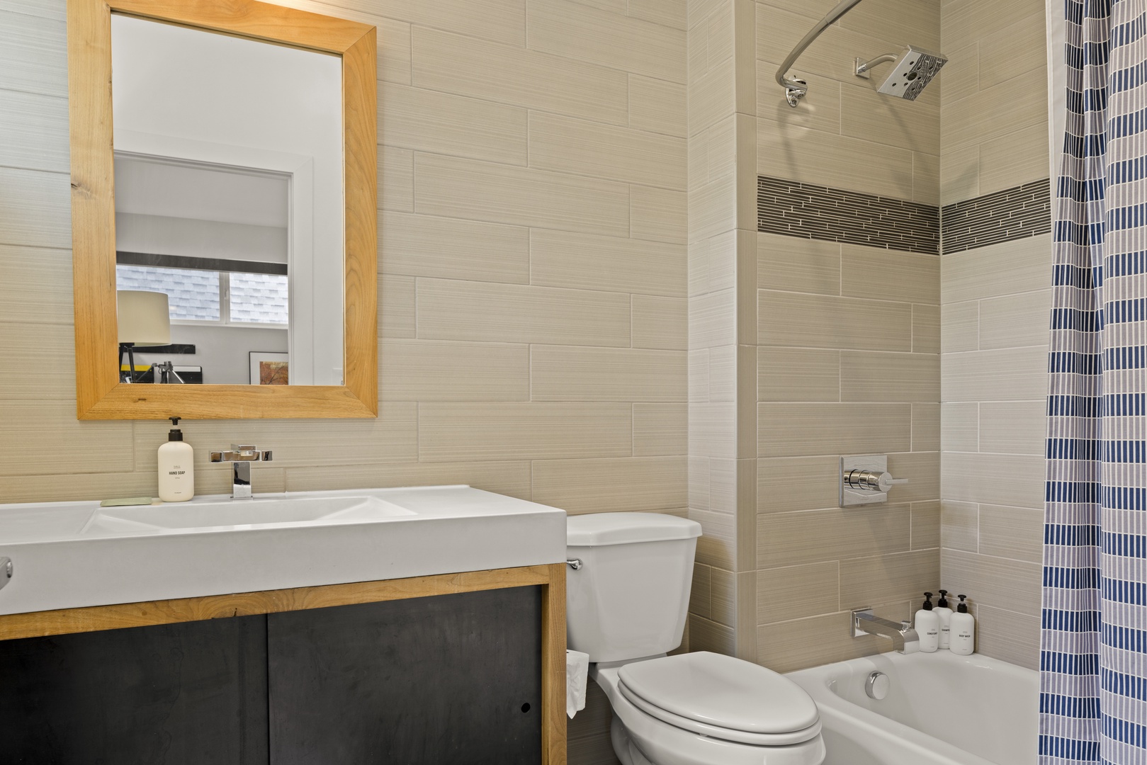 Unwind in your stylish bathroom featuring modern mosaic tiles, spacious vanity, and refreshing shower-tub combo for ultimate relaxation.
