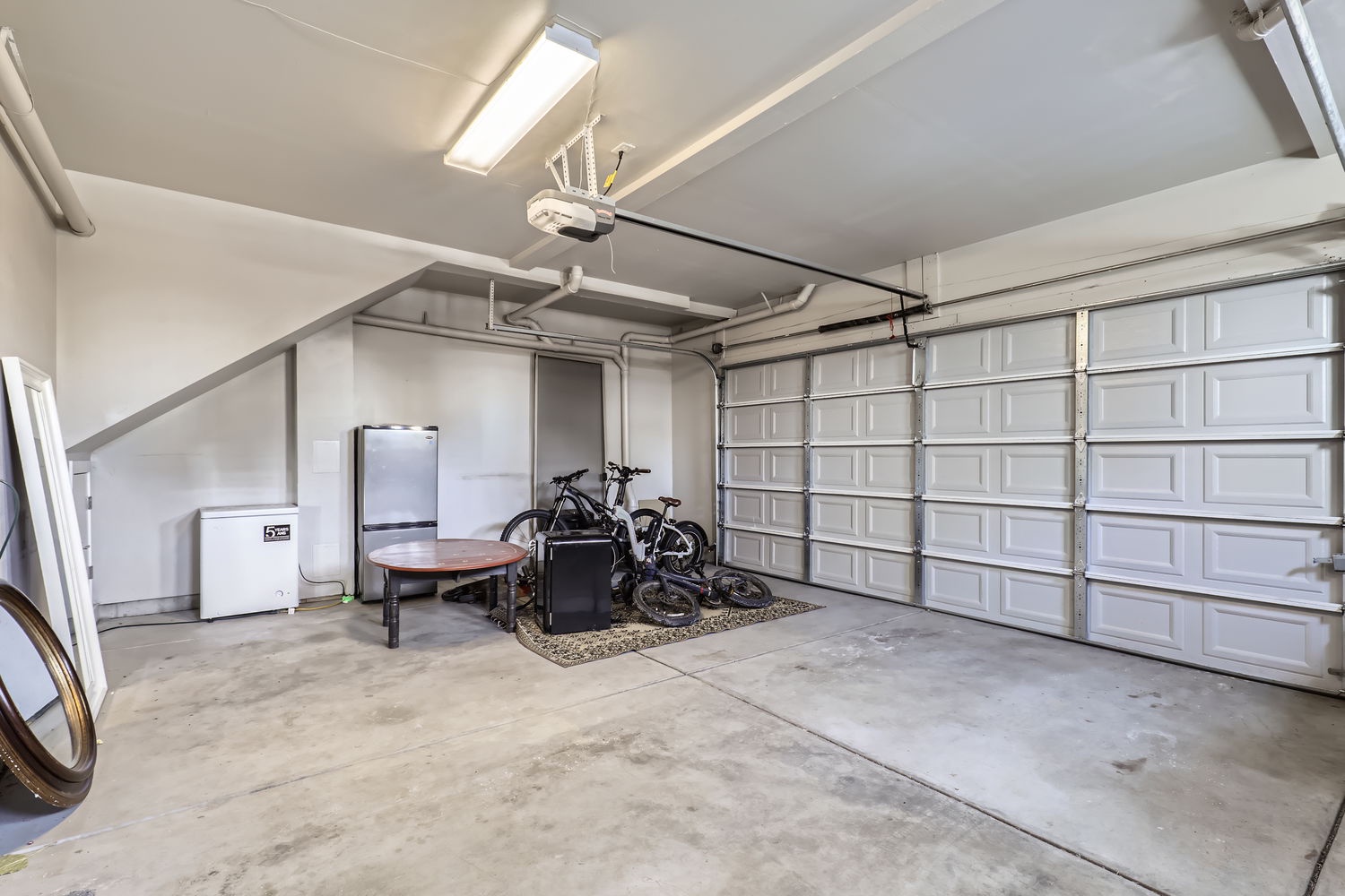 Your private garage offers secure parking plus convenient extras—a mini-fridge for drinks, a table for gear prep, and dedicated bike storage. Everything you need is ready and waiting.