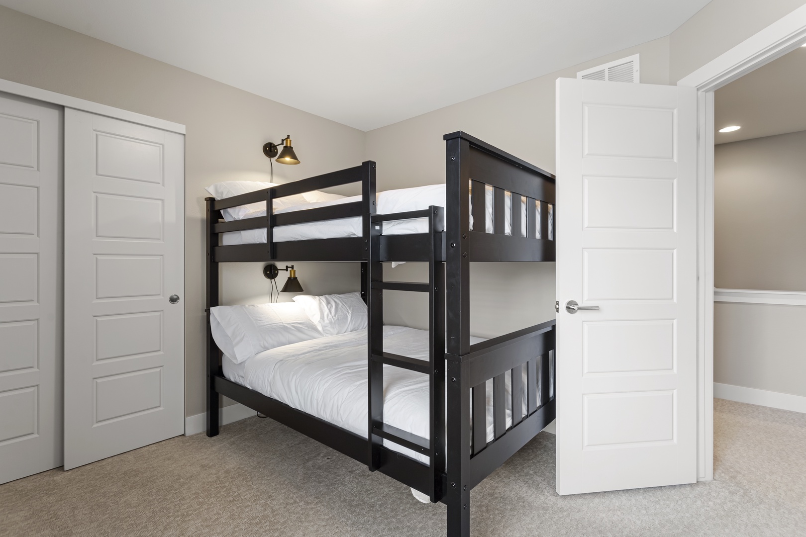 Your little ones will love this cozy bunk room with personal reading lights and crisp white bedding for restful nights.