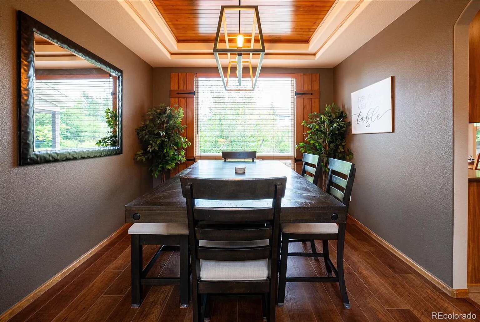 Gather around your elegant dining table where natural light streams through stunning windows, creating the perfect setting for memorable meals.