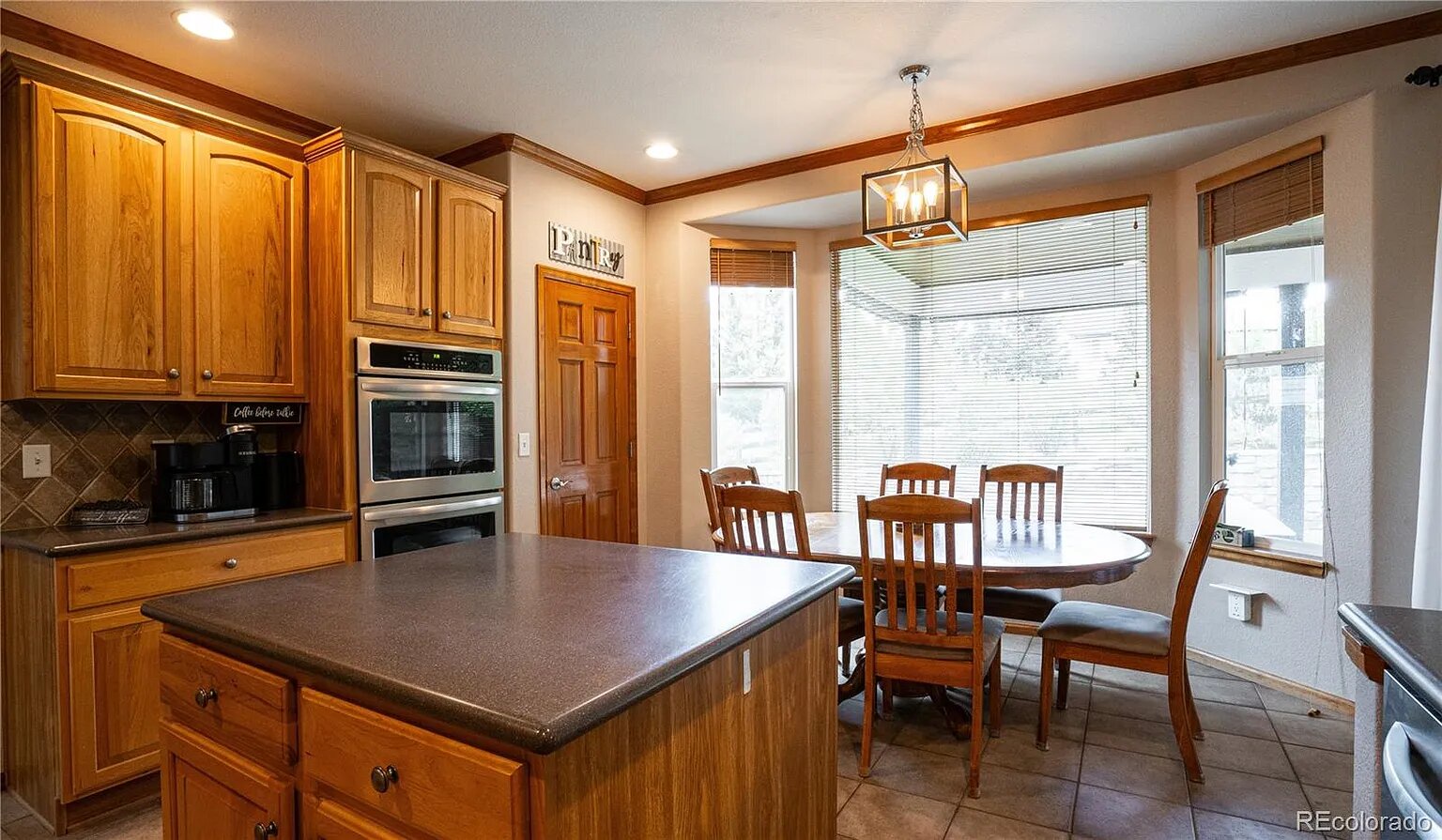 Your well-appointed kitchen offers rich wood cabinetry, granite countertops, and a cozy breakfast nook where you can enjoy morning coffee with snowy mountain views.