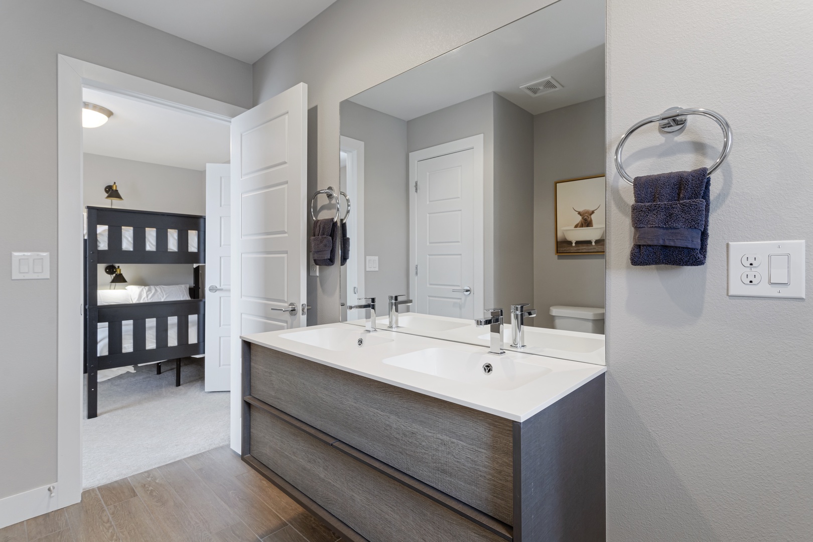 Refresh in your spacious ensuite with dual sinks, crisp white counters, and soft towels waiting for you.