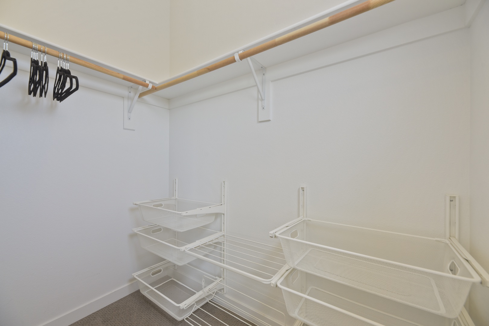 Your spacious walk-in closet features sturdy hanging rods and clever wire shelving, giving you plenty of room to unpack and settle in comfortably.