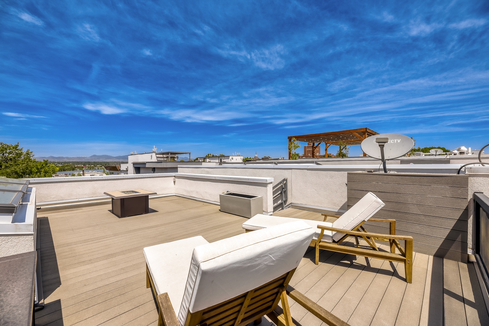 Soak up the sun on your private rooftop terrace, where blue skies stretch endlessly above and comfortable loungers invite you to unwind with sweeping views of the horizon.