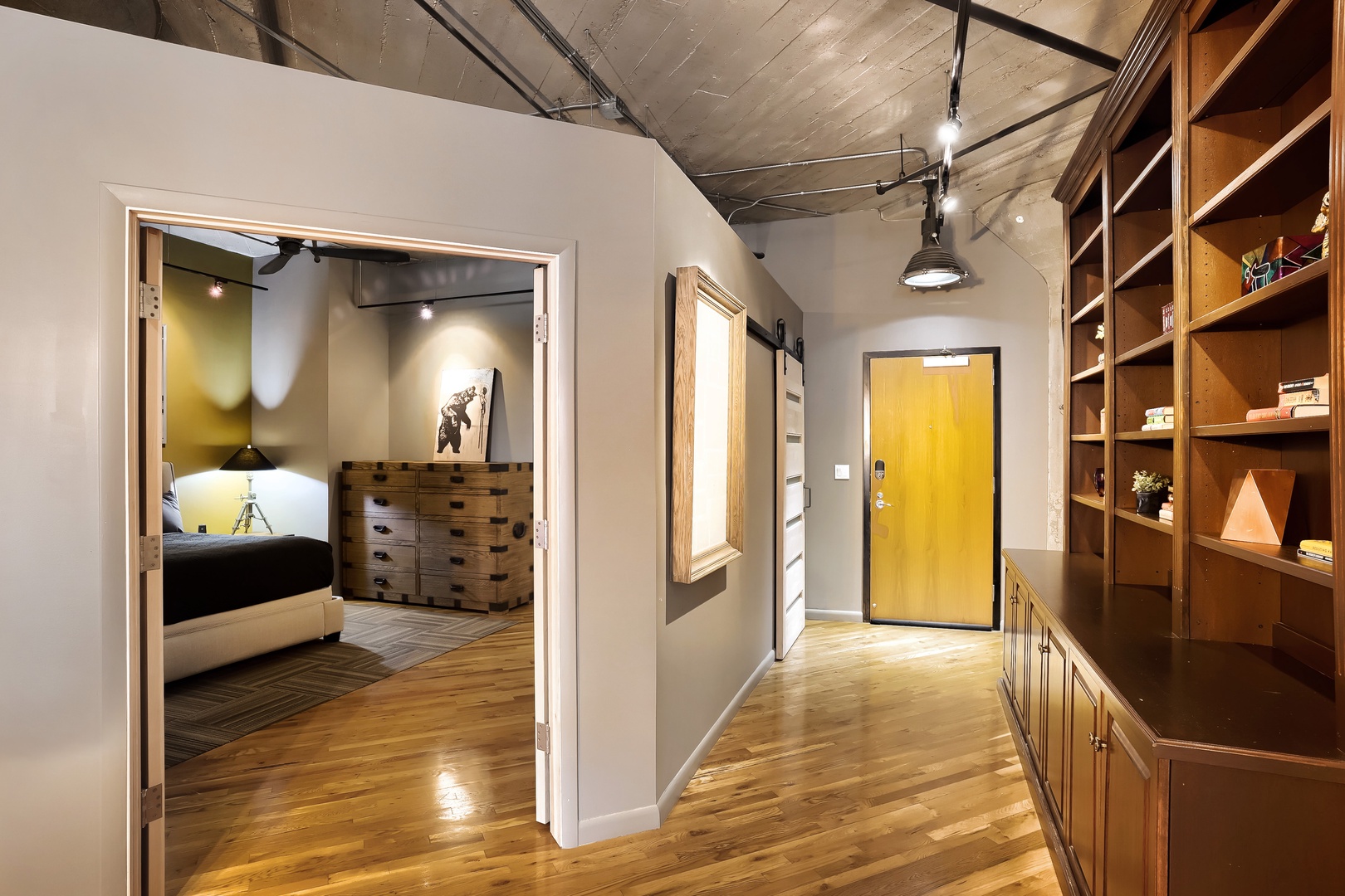 Warm wood floors and stylish built-in shelving welcome you into this modern loft, where exposed ceilings and industrial lighting add urban character to your stay.