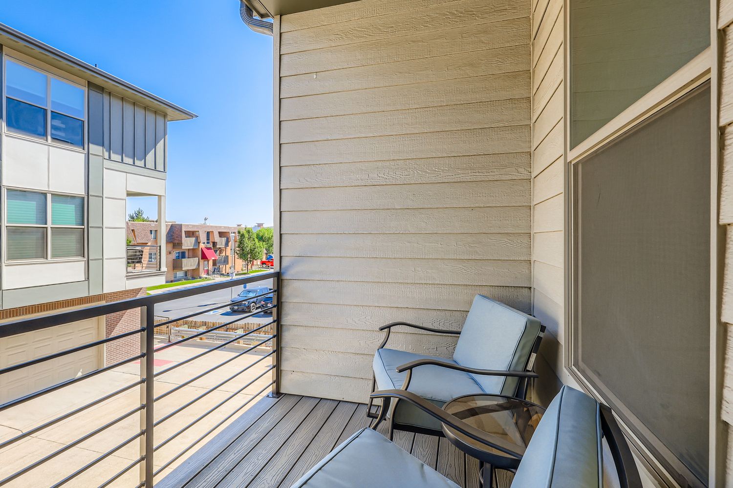 Step out onto your private balcony with comfortable seating, perfect for sipping morning coffee while taking in the neighborhood views and fresh air.