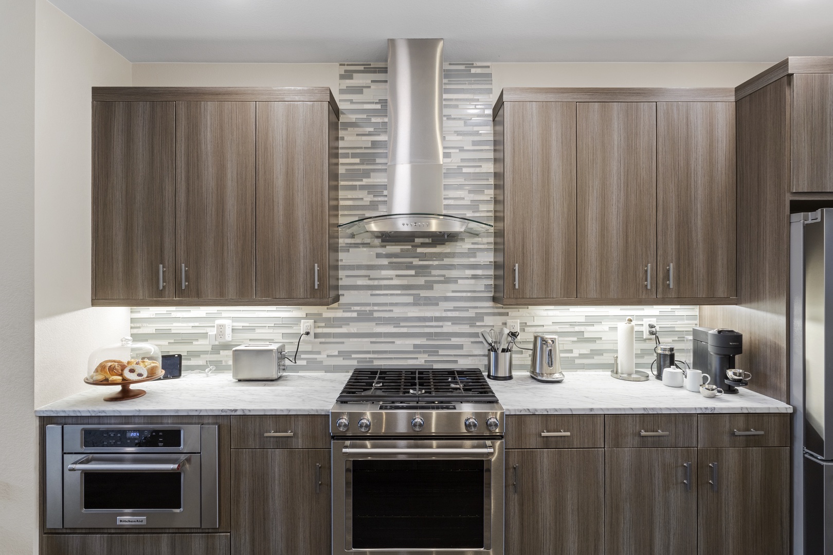 Your fully equipped kitchen features sleek appliances and ample counter space for preparing memorable meals during your stay.