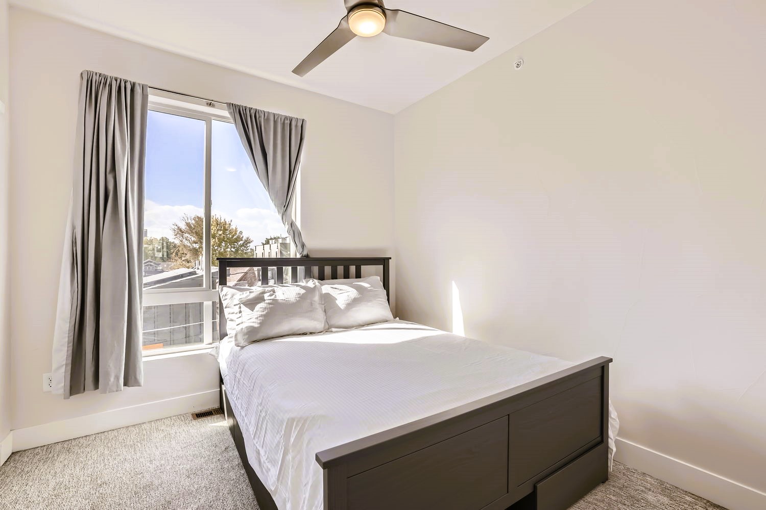 Rest peacefully in your bright bedroom with crisp linens and a gentle ceiling fan keeping you comfortable throughout the night.