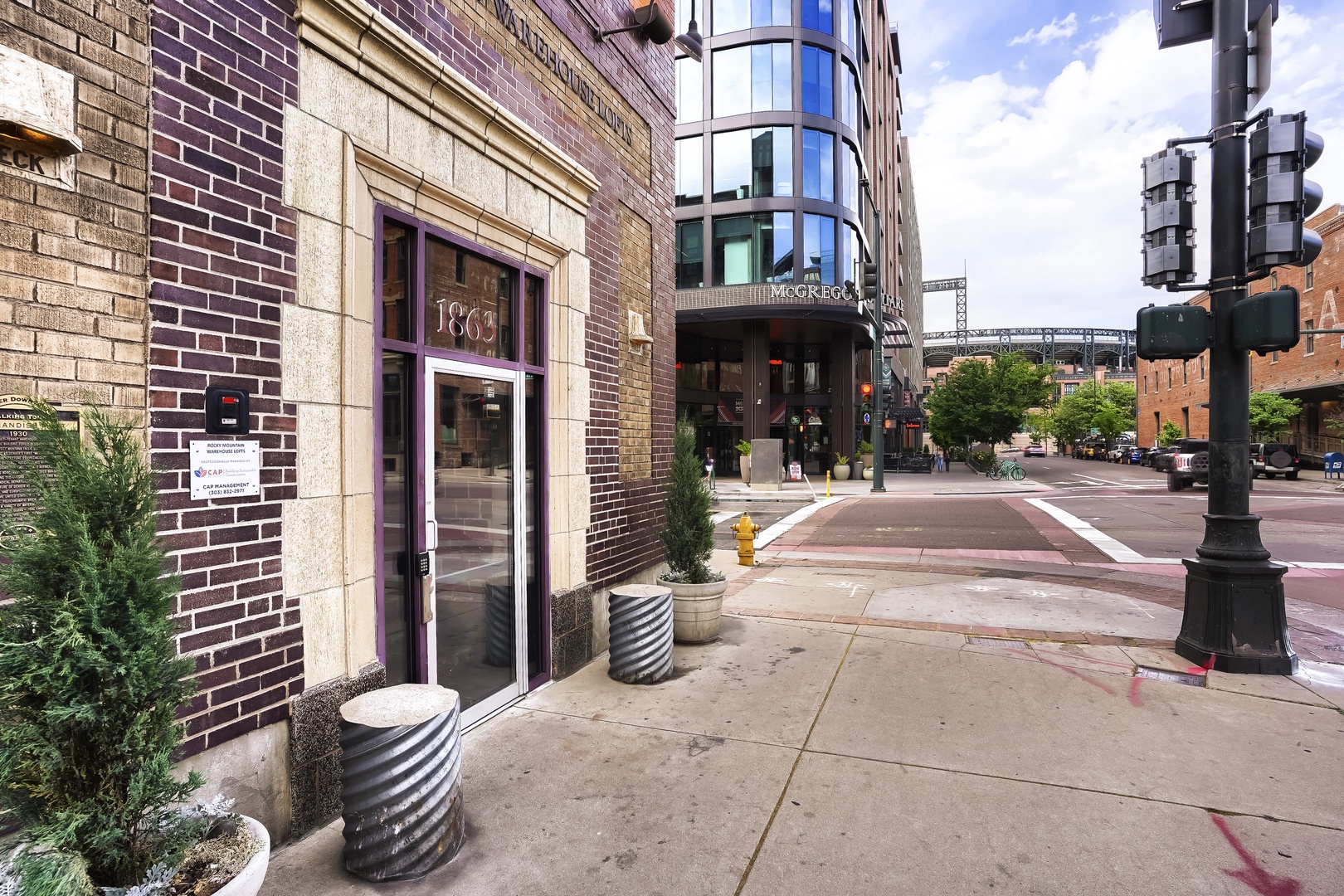 Historic 1863 building entrance sits on a vibrant downtown street, blending classic brick architecture with modern city energy nearby.