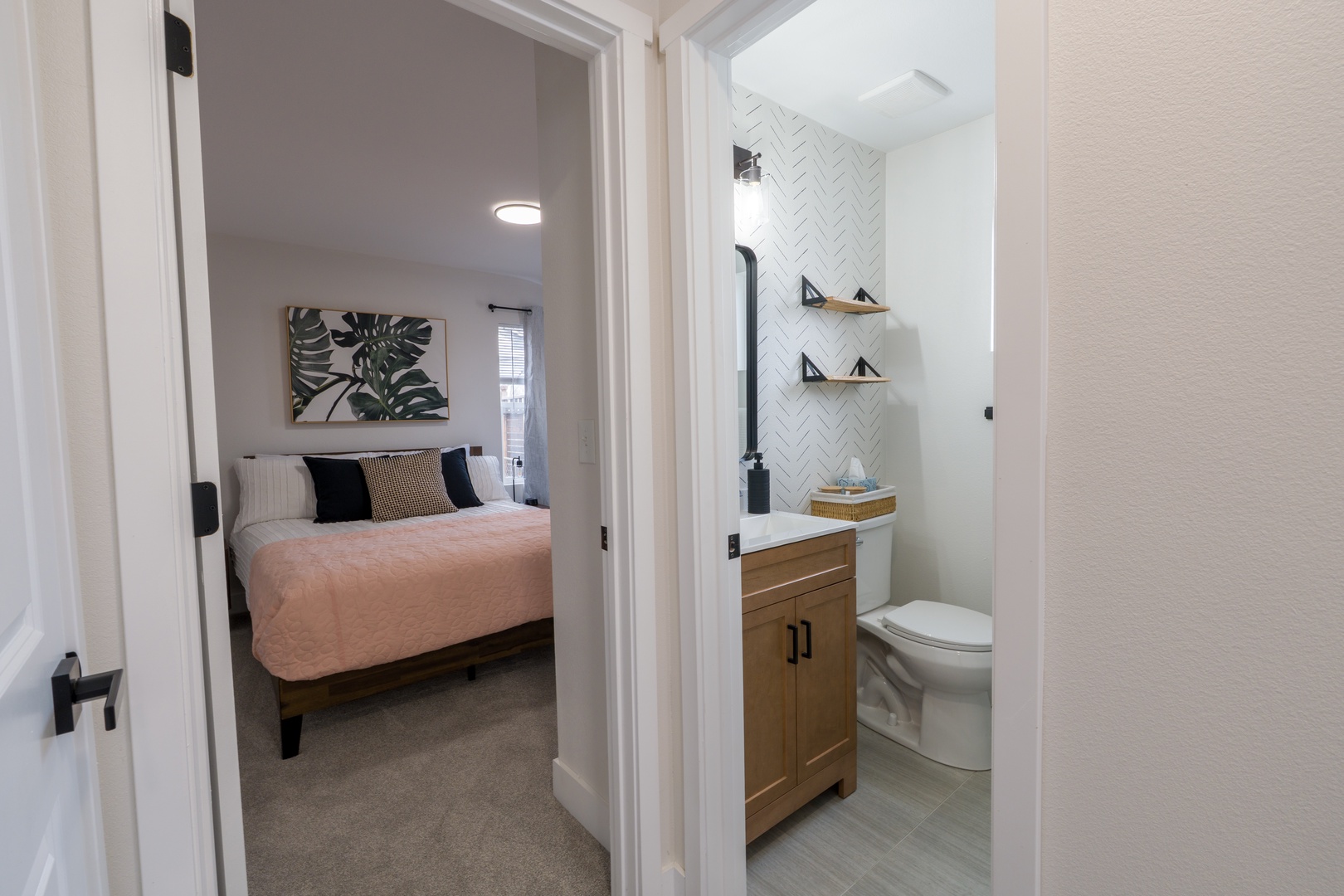 Your private suite features a cozy bedroom and modern ensuite bathroom with stylish herringbone tiles and custom vanity.