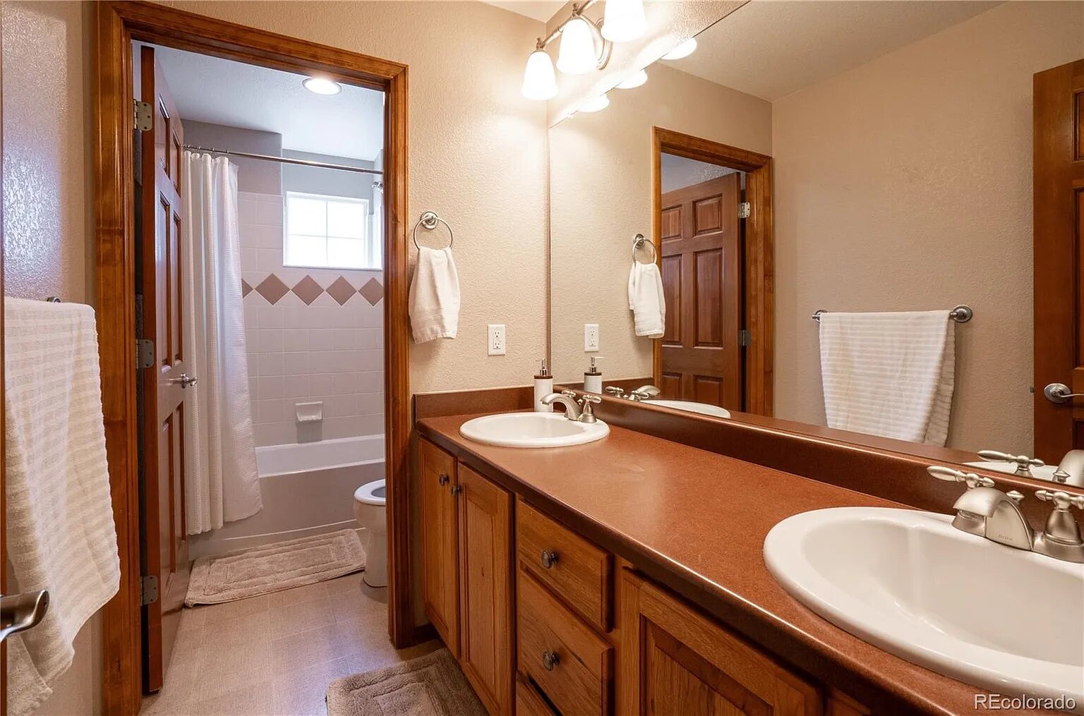 Refresh in your spacious dual-vanity bathroom with warm wood finishes and fresh towels ready for your mountain getaway.