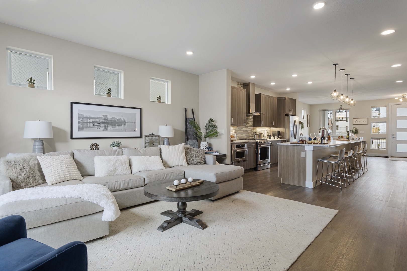 Relax in your spacious open-plan living area where plush seating and a gourmet kitchen create the perfect space for unwinding.