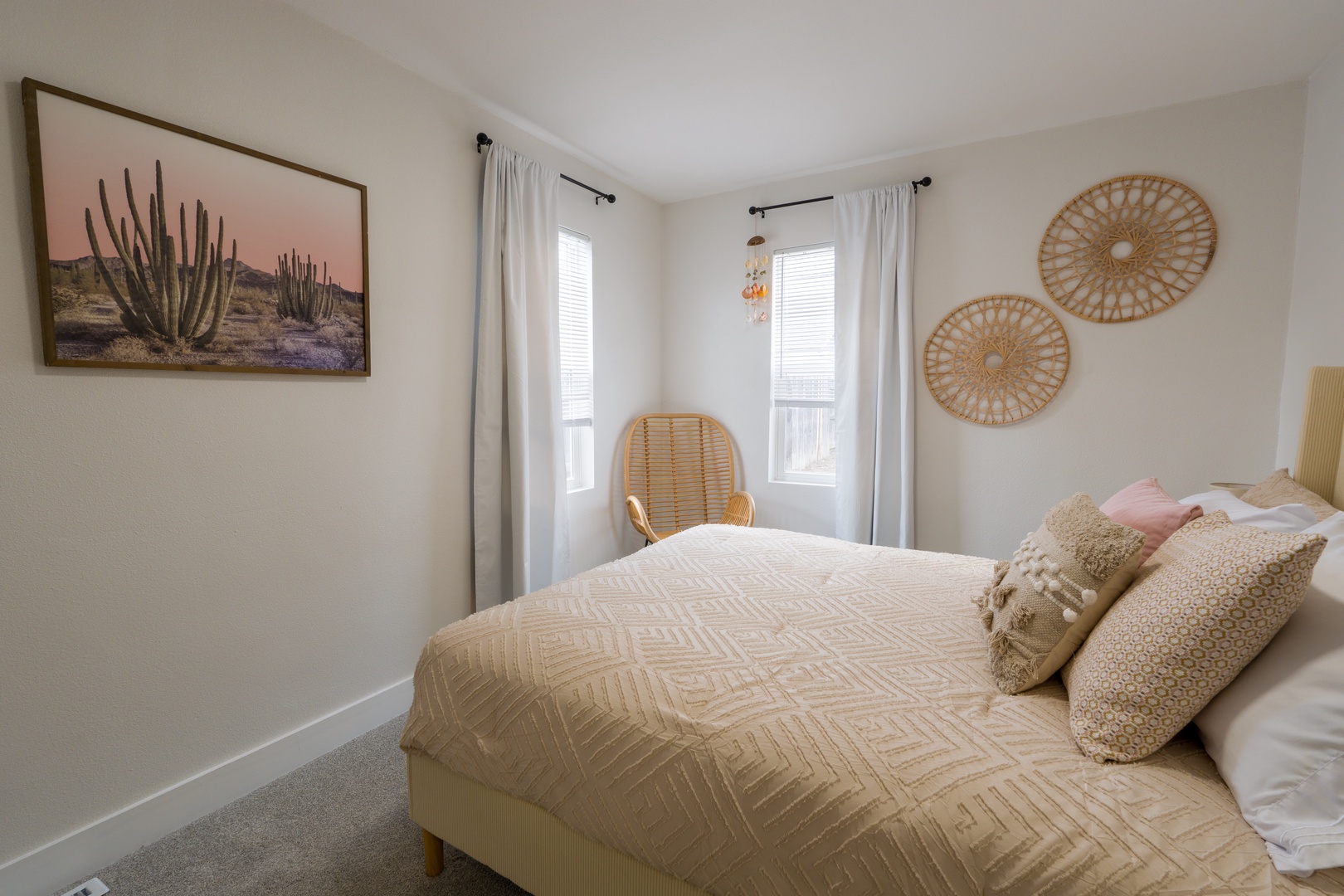 Sink into soft linens and drift off in this serene bedroom, where natural light filters through crisp curtains and warm textures create your perfect retreat.