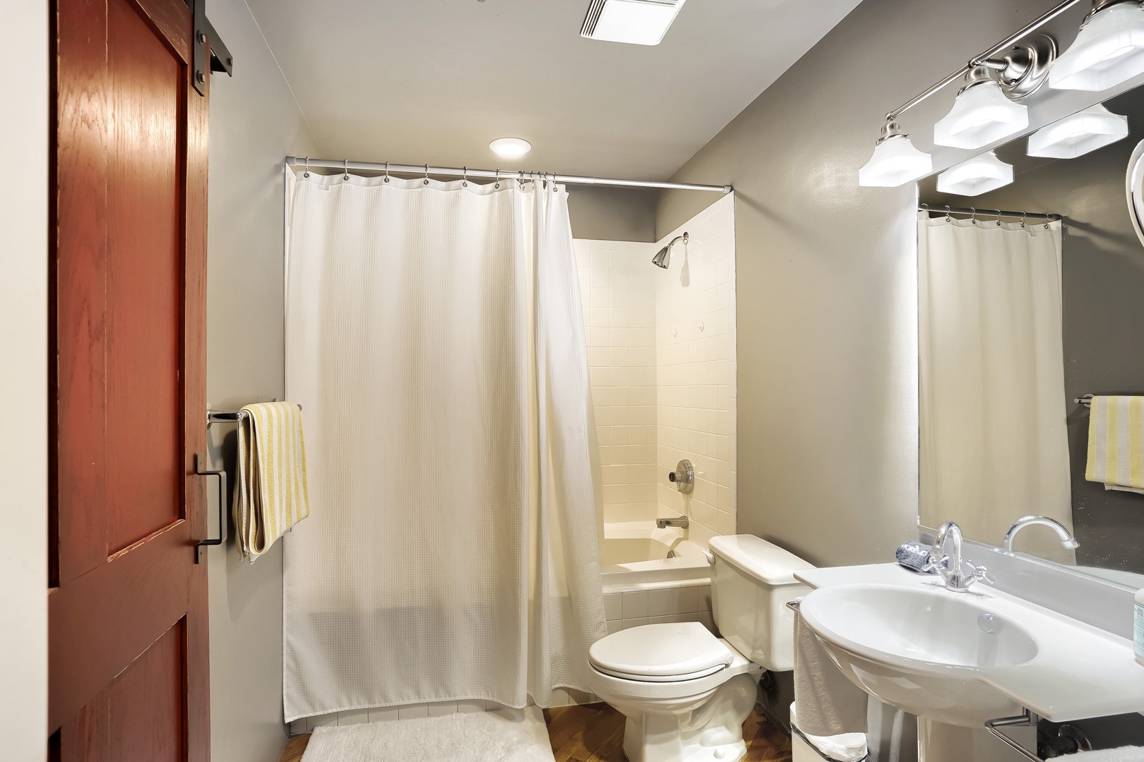 Step into your private, well-lit bathroom with a spacious tub-shower combo, fresh towels at the ready, and everything you need for a refreshing start to your day.