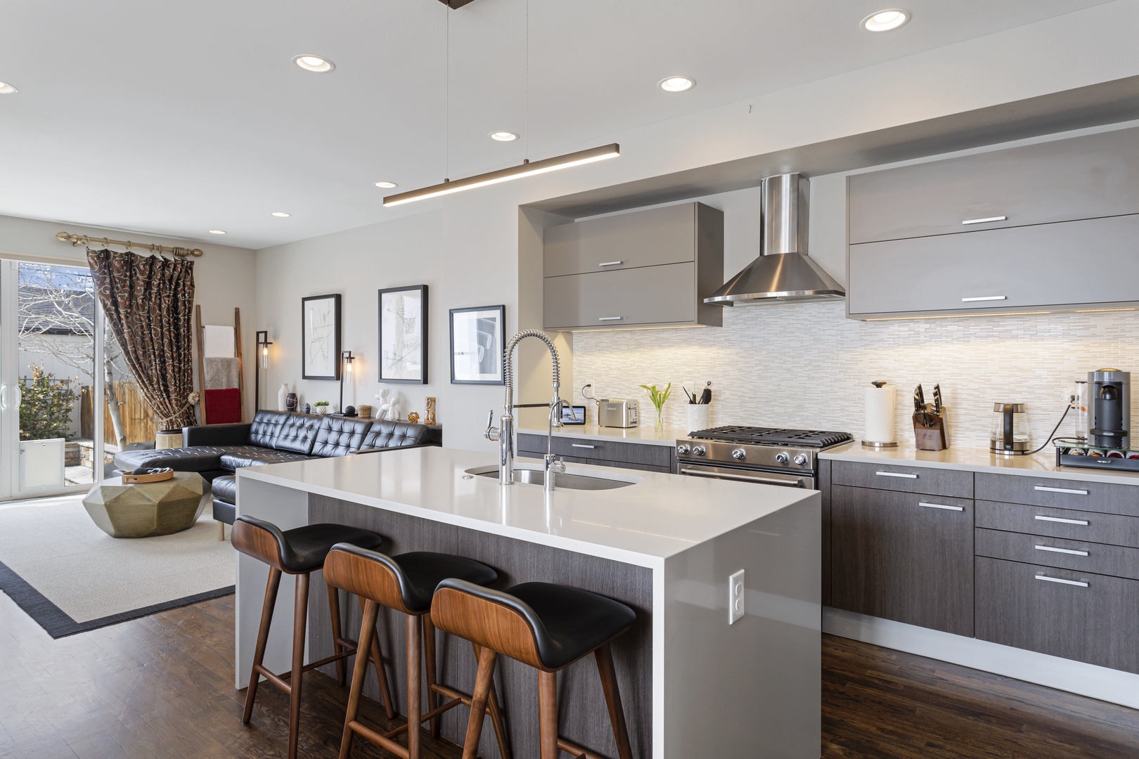 Your sleek modern kitchen features premium appliances and a spacious island perfect for morning coffee or evening meals.