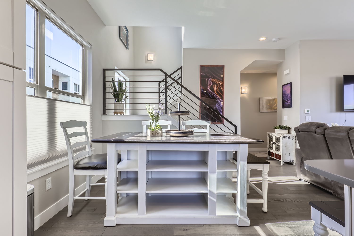 Bright and airy space with soaring ceilings, modern artwork, and stylish open-concept living—perfect for relaxing or gathering with your group after a day exploring.