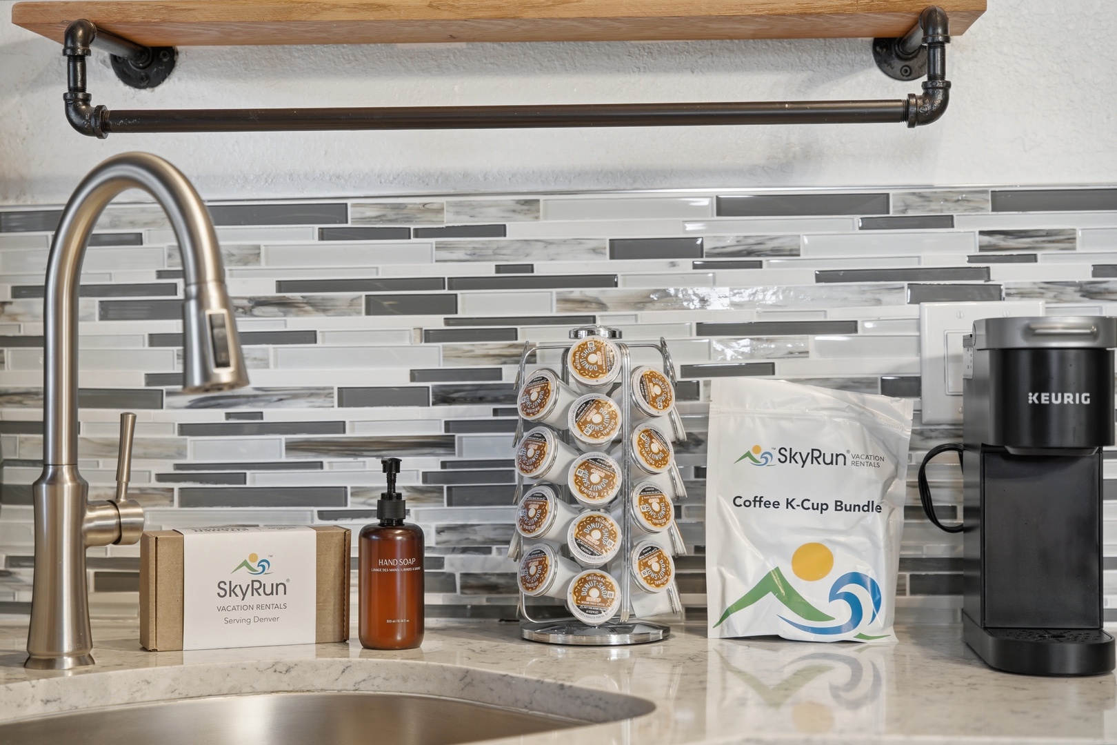 Brew your morning coffee with ease at the modern kitchenette station, featuring a Keurig and K-Cup carousel ready for your favorite blend.