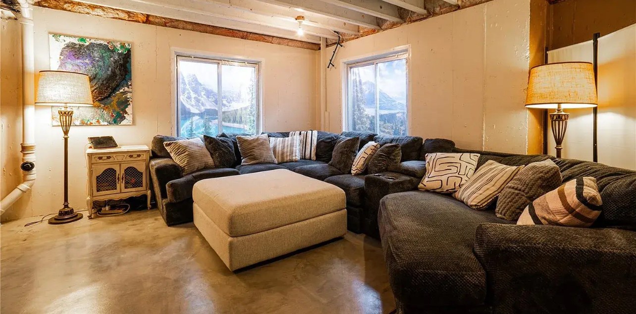 Sink into this cozy sectional and unwind beneath rustic beams, where mountain views frame your perfect retreat.