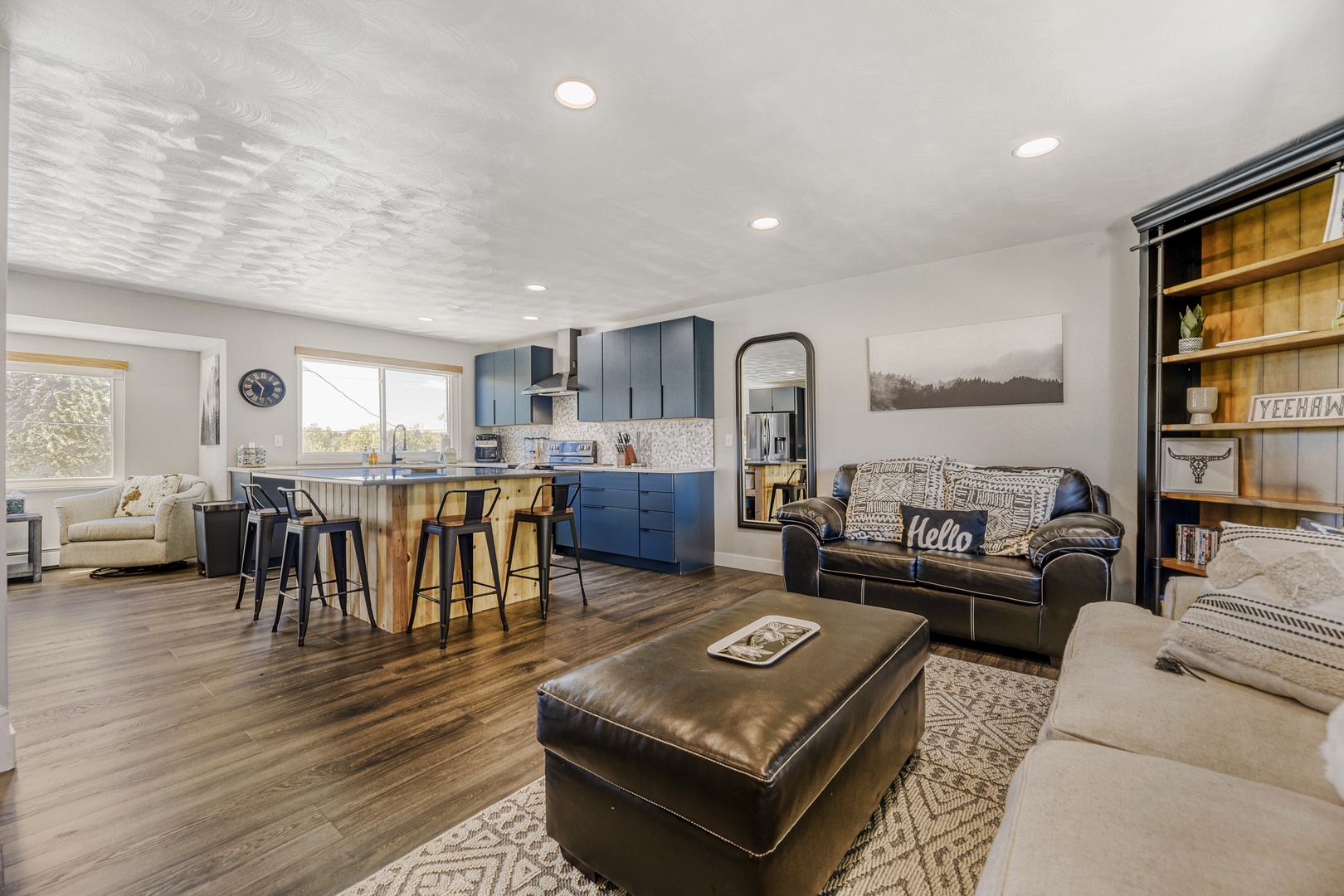 Sink into plush leather seating or gather around the rustic dining bar in this open, light-filled space where modern design meets warm, natural textures—perfect for your group getaway.