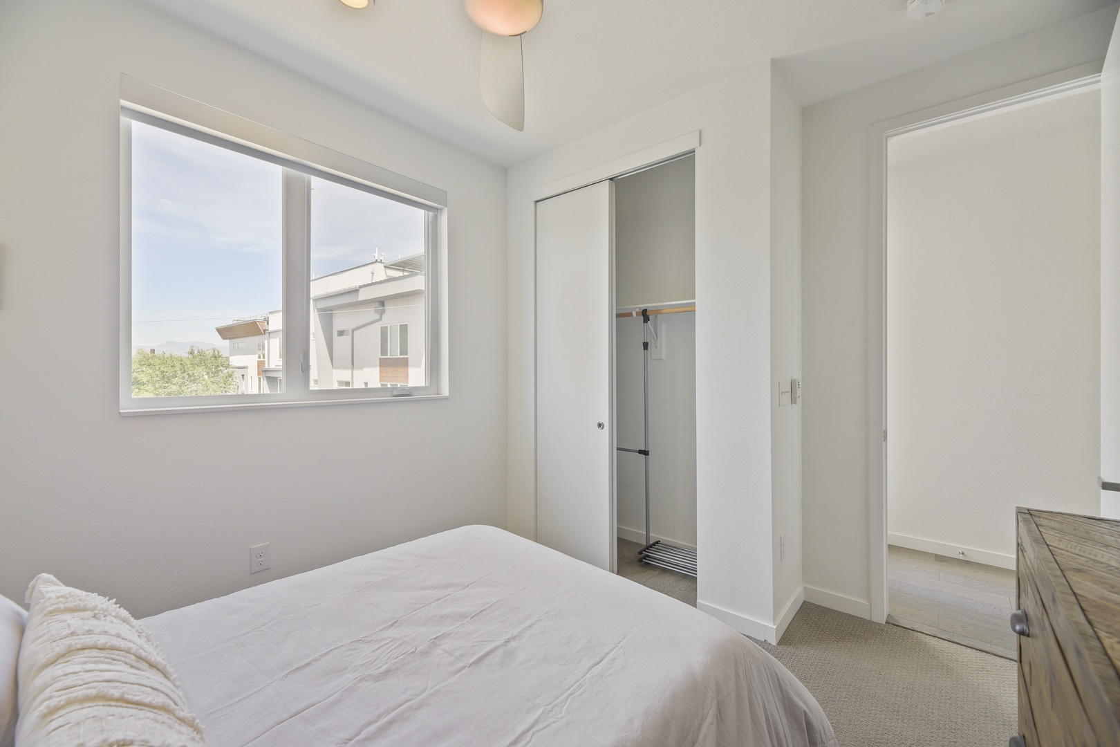 Wake up to bright natural light in your peaceful bedroom, where soft neutral tones and comfortable bedding create your personal retreat. Step into your private closet and enjoy the clean, modern design.