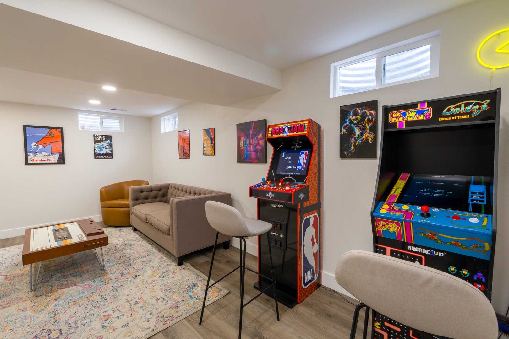 Your private arcade awaits with classic games and cozy seating - perfect for friendly competition and nostalgic fun.