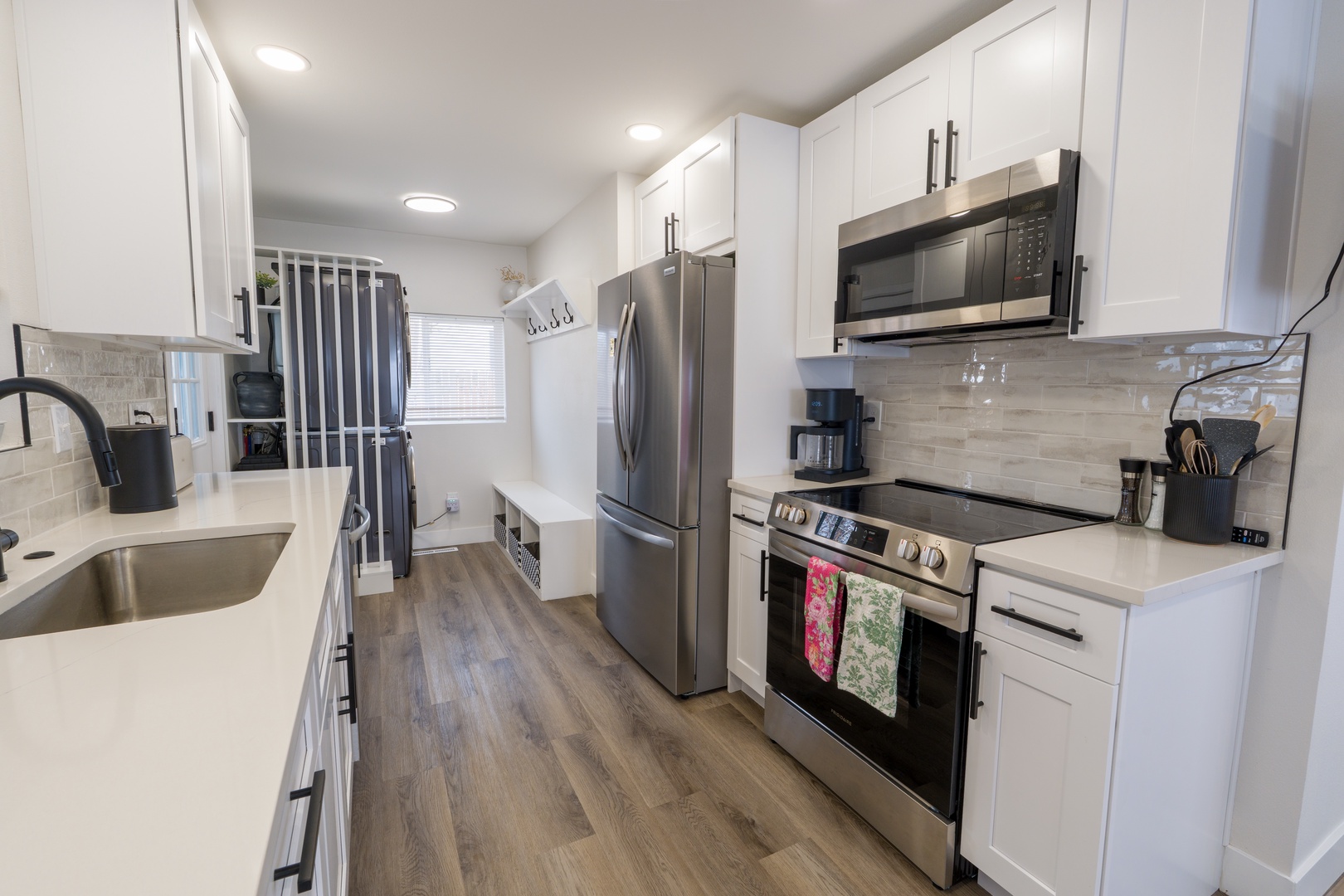 Your fully equipped kitchen features stainless steel appliances and pristine white cabinetry, perfect for preparing memorable meals during your stay.