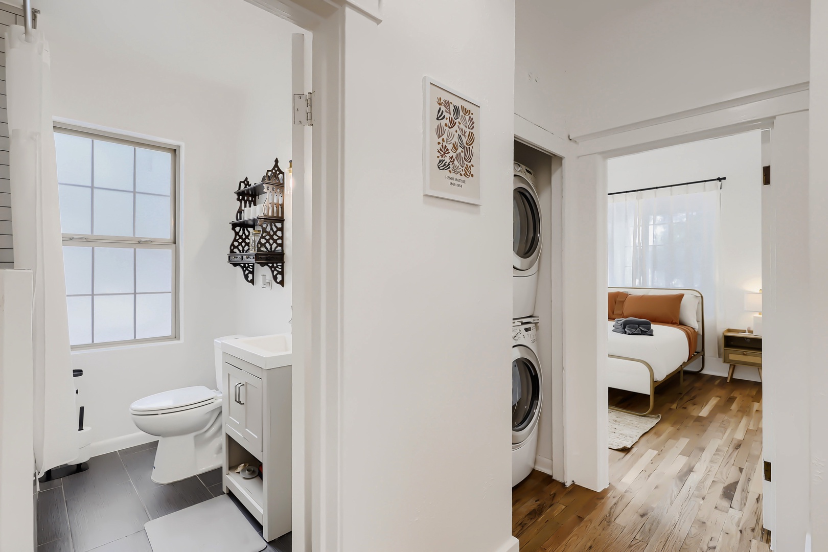A bright hallway connects your private bathroom, in-unit washer and dryer, and cozy bedroom—thoughtfully designed for effortless comfort during your stay.