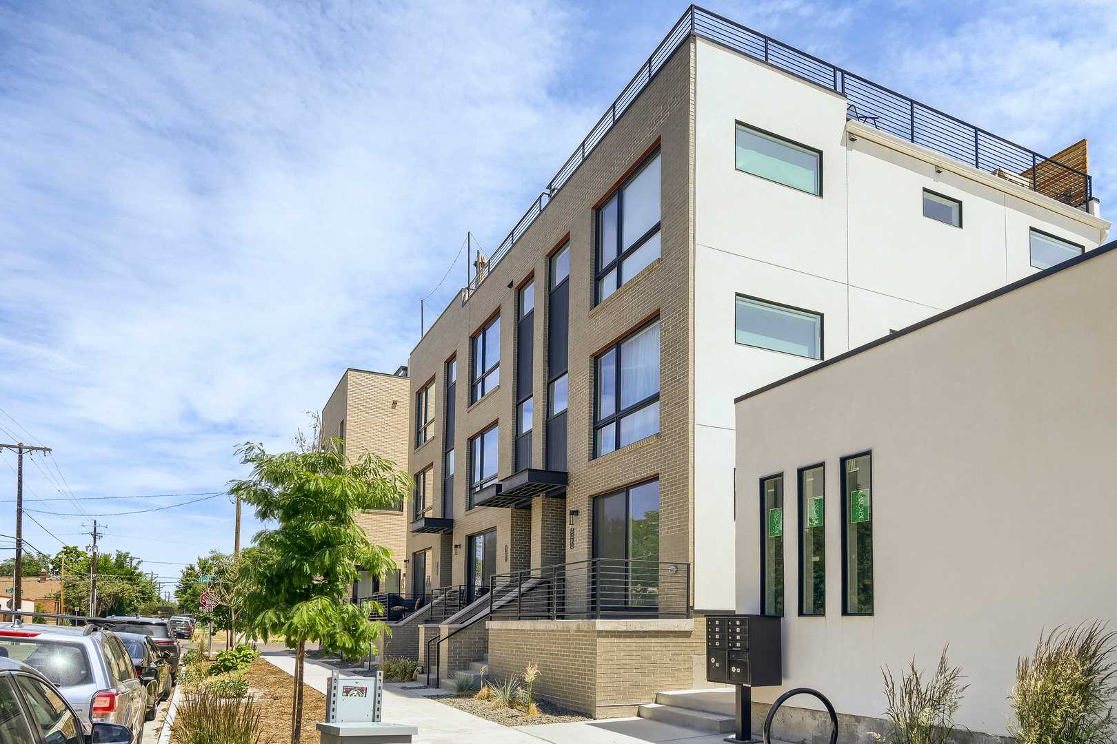 Modern multi-level property featuring clean architectural lines, rooftop terrace space, and contemporary design in a residential neighborhood setting.