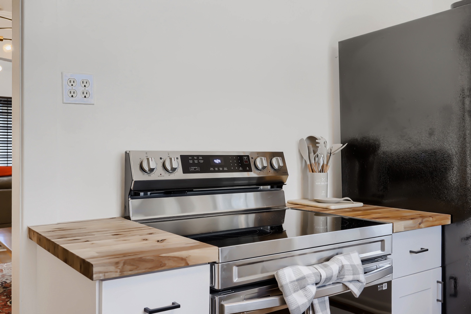 Your home away from home features a sleek stainless steel stove and warm butcher-block counters, perfect for cooking family meals together.