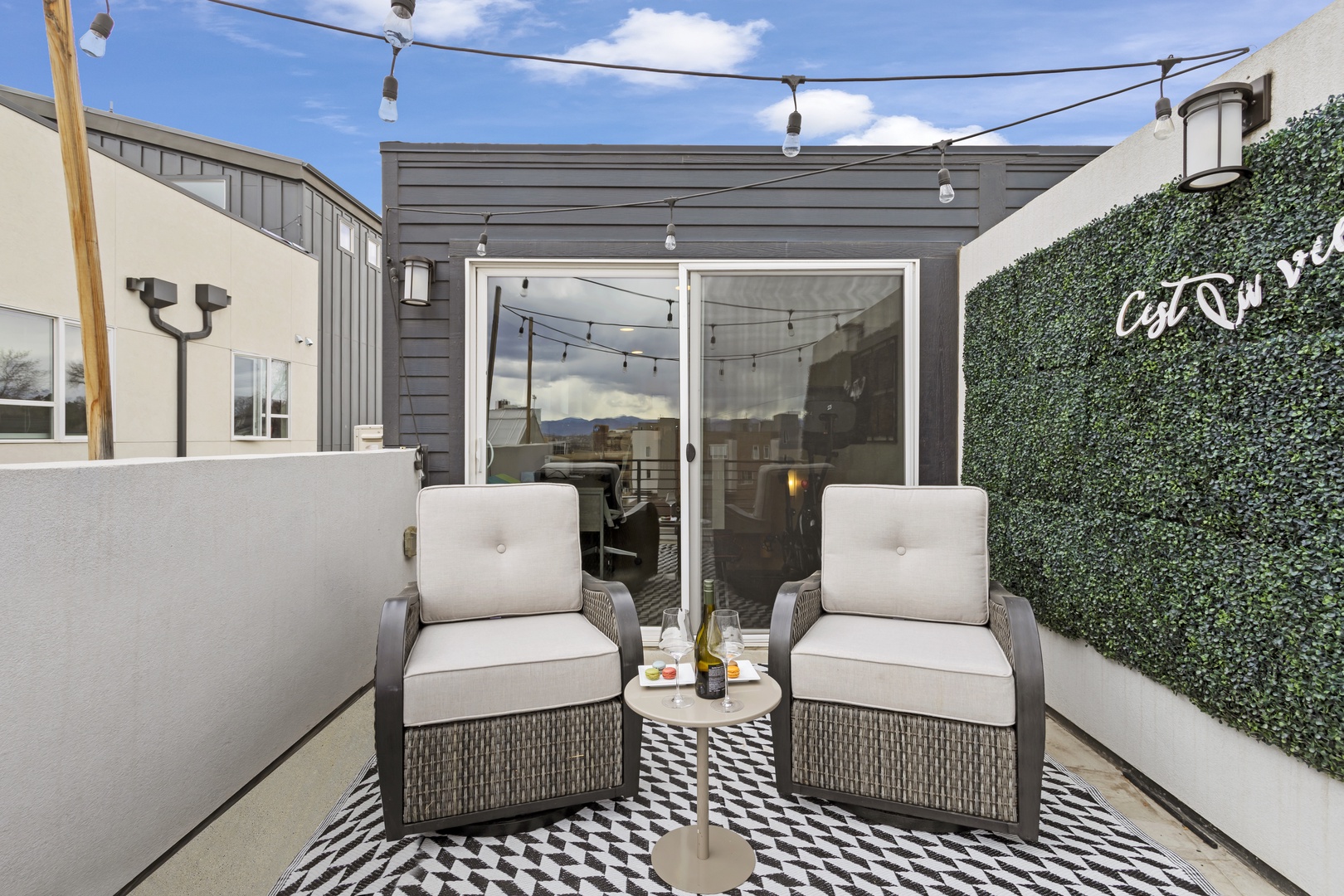 Unwind in your private rooftop sanctuary with plush seating and string lights creating the perfect ambiance for evening relaxation.