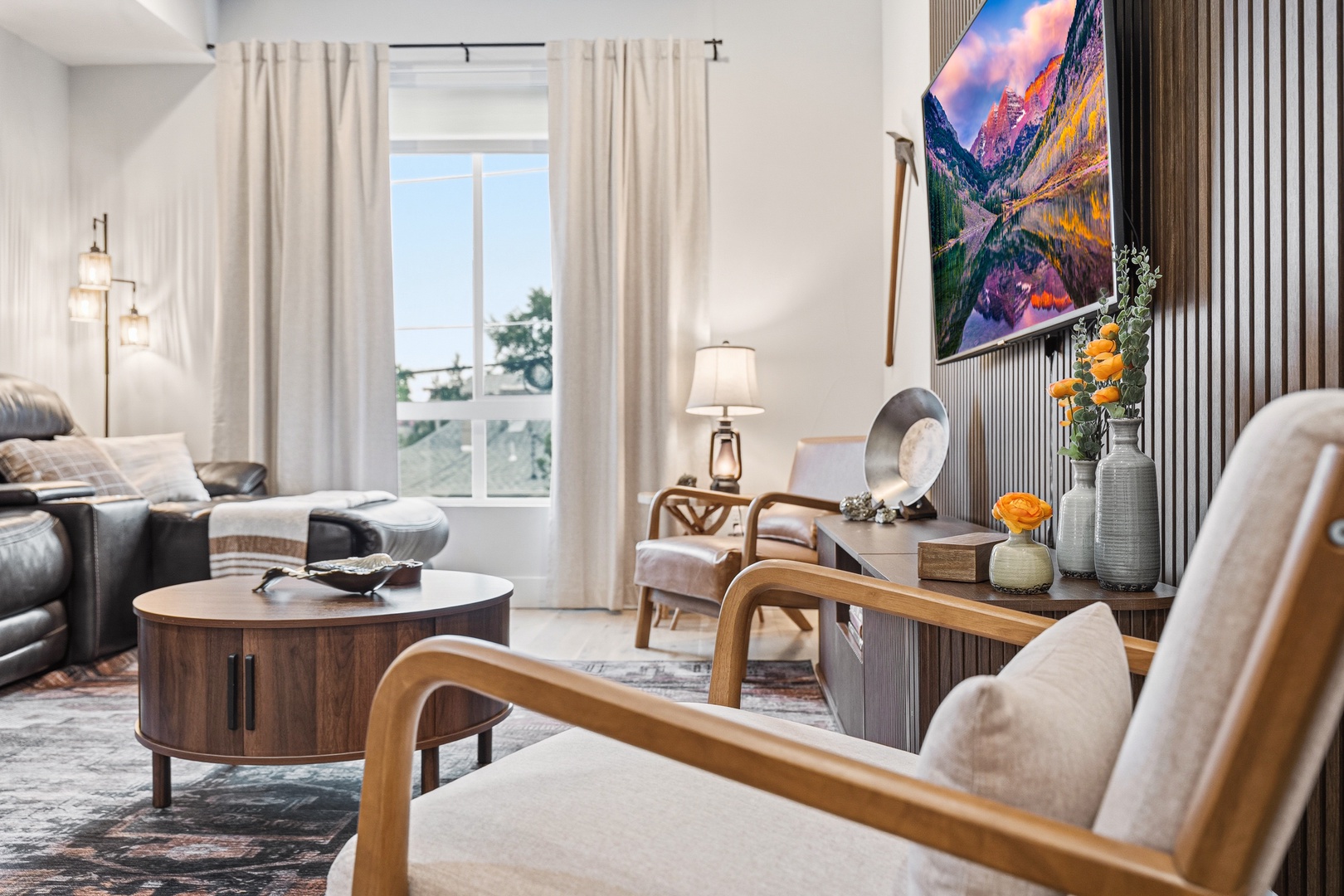 Sink into stylish comfort in your bright living room, where natural light streams through floor-to-ceiling windows. Relax on plush seating and enjoy modern amenities in this thoughtfully designed space.