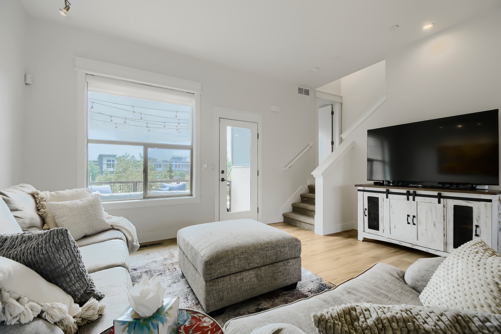 Settle into your light-filled living room, where plush seating and modern amenities create the perfect retreat after exploring the neighborhood.