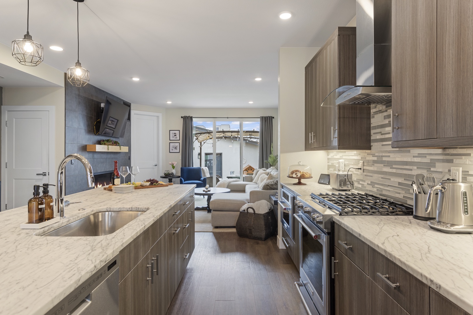 Your gourmet kitchen features marble counters, premium appliances, and flows seamlessly into the cozy living space.