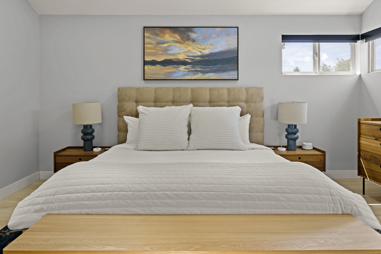 Sink into plush linens and wake to natural light streaming through your window in this serene bedroom retreat.