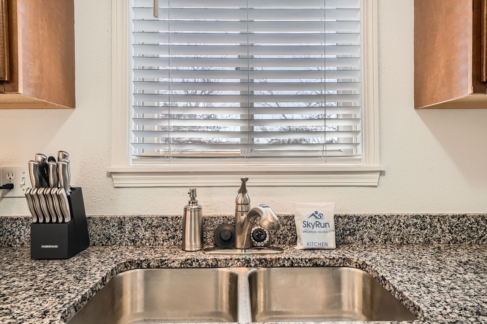 Your well-appointed kitchen sink features granite countertops, quality fixtures, and thoughtful amenities to make meal prep a breeze during your stay.