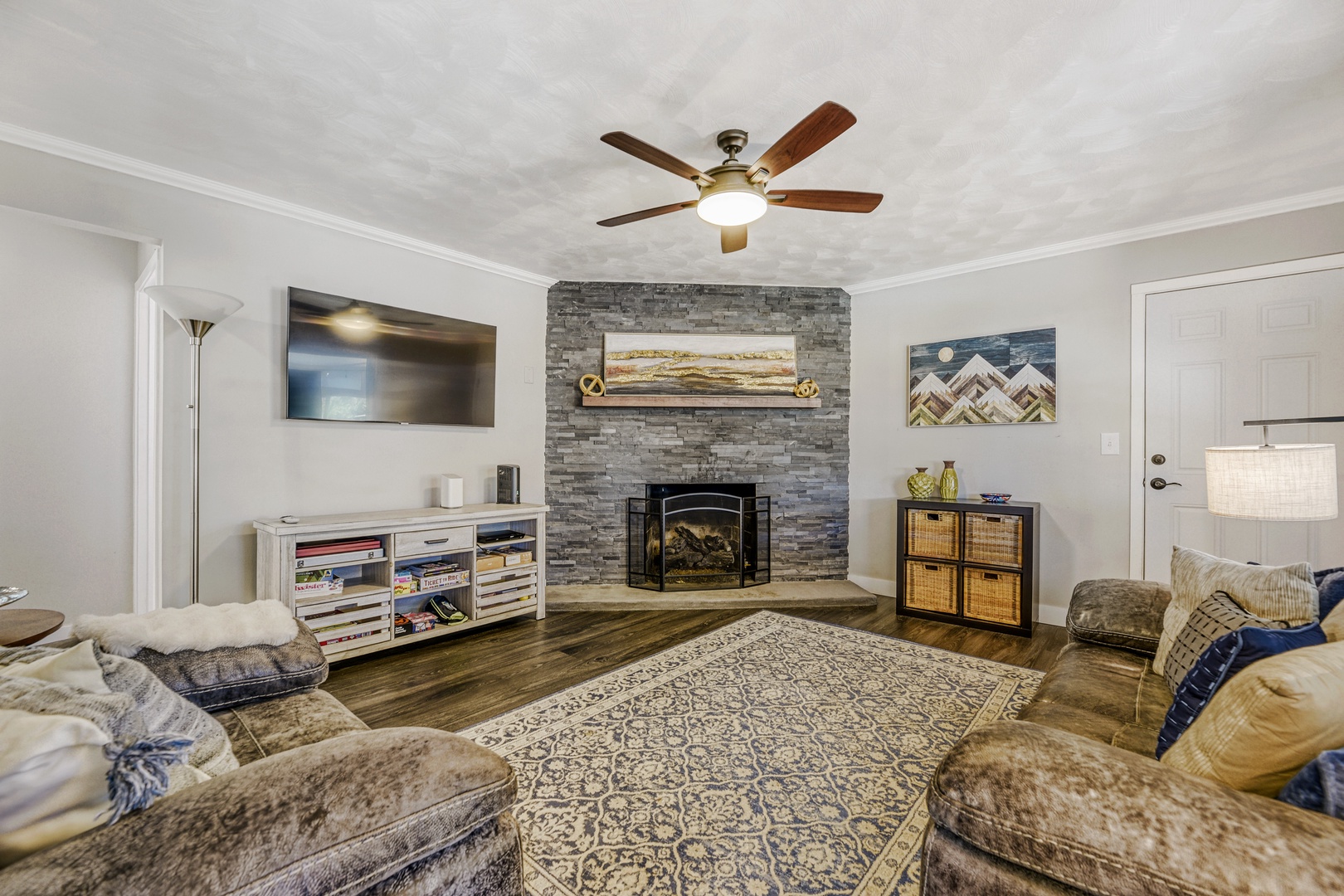 Unwind in your inviting living room, where a stone fireplace and plush seating create the perfect retreat after a day of adventure. Cozy up and relax in comfort.