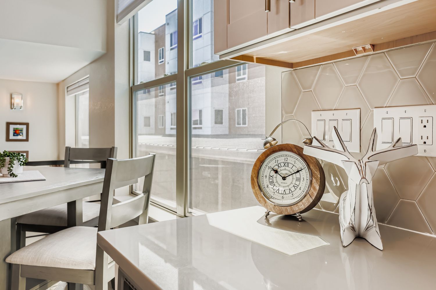 Gather around your bright dining space with modern amenities and street views. Clean countertops and stylish decor create the perfect setting for enjoying meals together during your stay.