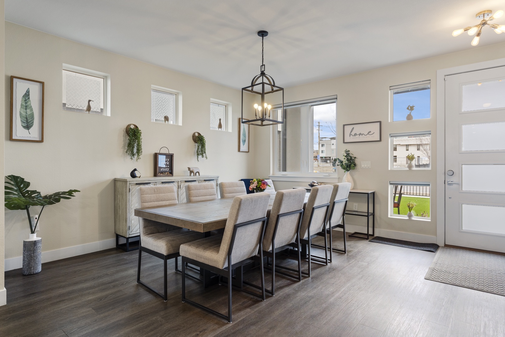 Your spacious dining room welcomes gatherings with warm lighting, modern furnishings, and plenty of natural light for memorable meals together.
