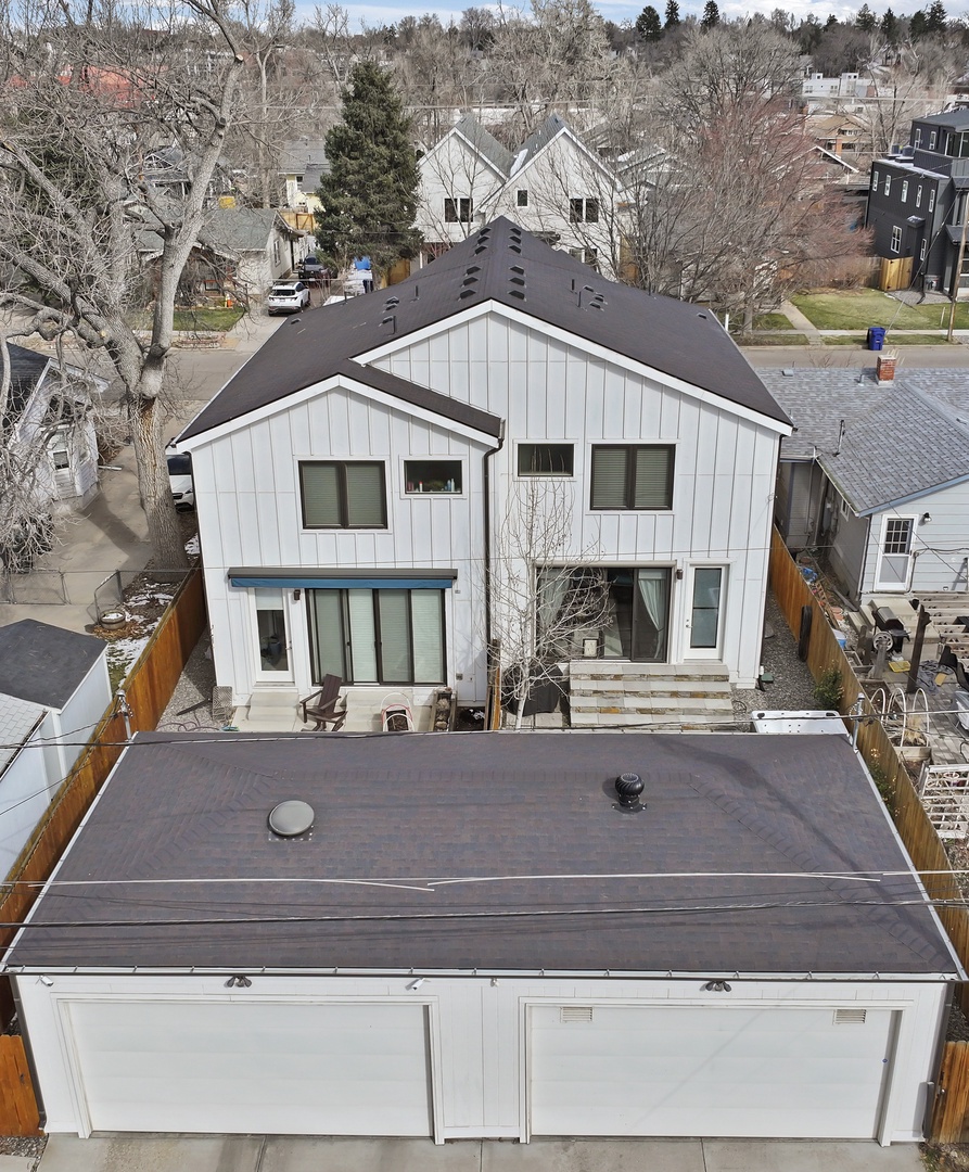 Modern duplex property featuring contemporary architecture with board-and-batten siding and distinctive rooflines in established neighborhood.